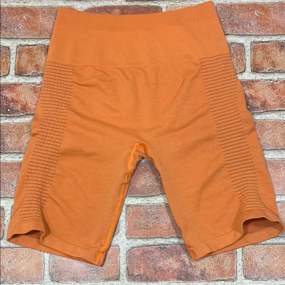 Alphalete Seamless Orange Ribbed Biker Shorts. Size M